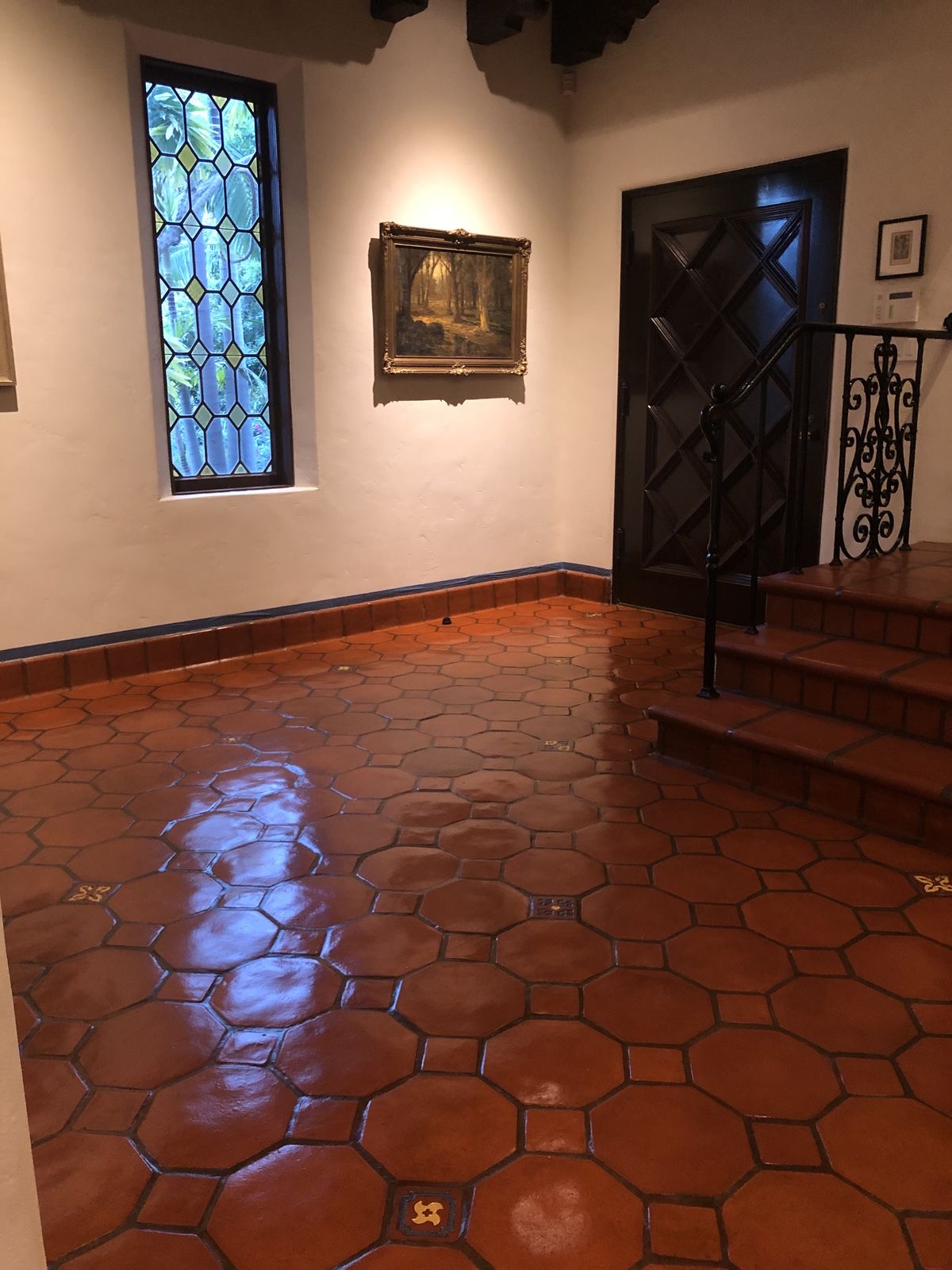 Restored and sealed Saltillo terracotta tile floor with a warm finish