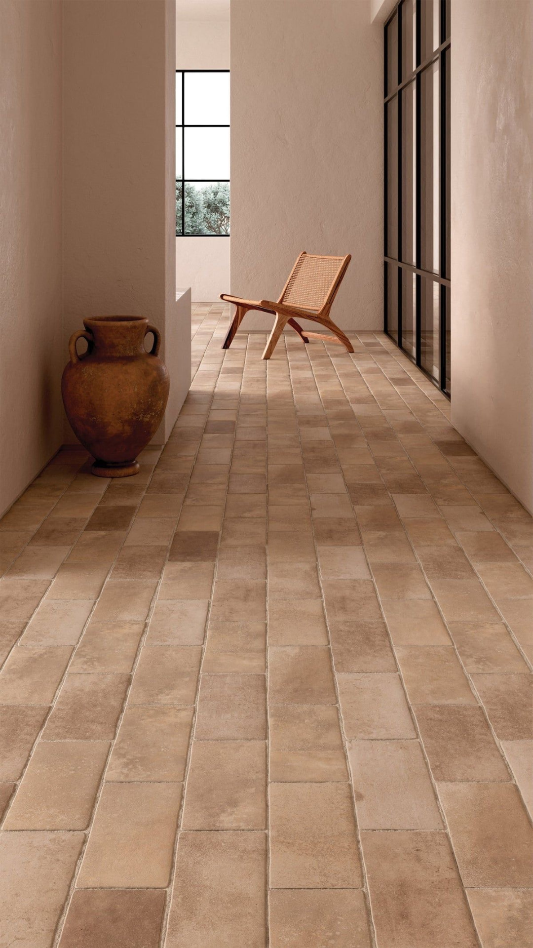 Warm terracotta tile floor restored to a clean, even finish in a bright hallway